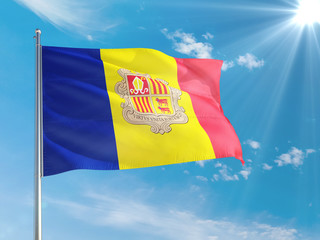Andorra national flag waving in the wind against deep blue sky. High quality fabric. International relations concept.