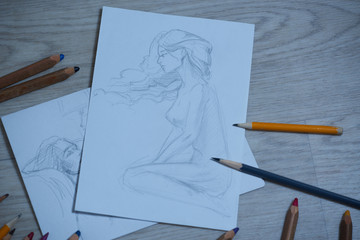 Sketches, sketching on white paper with a simple pencil. Colour pencils.