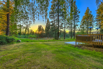Luxury summer mountain home front and back yard.