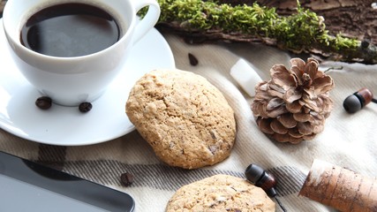 Working in harmony with nature during the coronavirus outbreak concept selective focus of coffee cup, chocolate cookies, pine cone, tablet, headphones and other nature themed objects