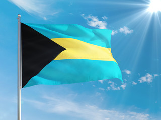 Bahamas national flag waving in the wind against deep blue sky. High quality fabric. International relations concept.