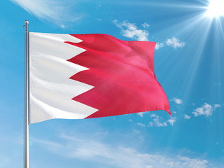 Bahrain national flag waving in the wind against deep blue sky. High quality fabric. International relations concept.