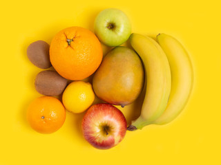 Fruit on a yellow background. The concept of healthy eating, vegan. vegetarianism. Copy location, top view.