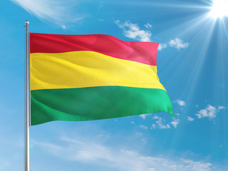 Bolivia national flag waving in the wind against deep blue sky. High quality fabric. International relations concept.