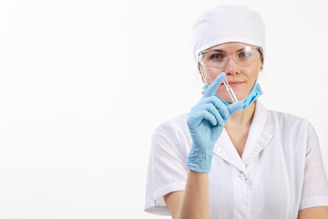 A doctor in a white coat looks at the medication.