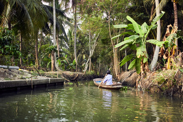 Woman rowing on single boat in Bali
