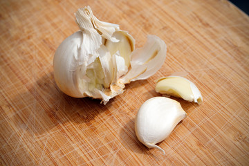 Garlic and cloves on a wooden board
