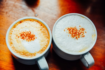 Two Coffee cup of cappuccino on the wooden table ,Street coffee, top view.