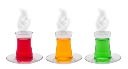 A glass of orange, green mint and red cherry tea with smoke