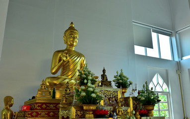 Golden statue of buddha in temple, Thailand	