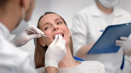 Face smiling woman with open mouth at dental checkup in stomatology. Close up shot on 4k RED camera
