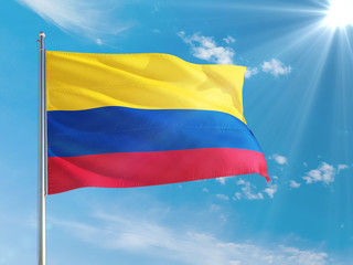 Colombia national flag waving in the wind against deep blue sky. High quality fabric. International relations concept.