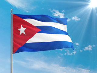 Cuba national flag waving in the wind against deep blue sky. High quality fabric. International relations concept.