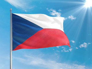 Czech Republic national flag waving in the wind against deep blue sky. High quality fabric. International relations concept.