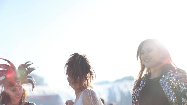 Female friends dancing at summer festival