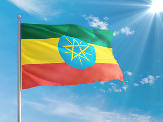 Ethiopia national flag waving in the wind against deep blue sky. High quality fabric. International relations concept.