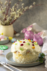 Holiday salad is not a sweet cake. Salad with rice, egg, crab sticks and cucumber on a stone or concrete on a light countertop. Copy space.