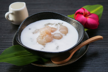 Sticky rice boiled in syrup with longan and coconut milk dressing. Thai dessert