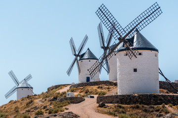 several white wooden windmills