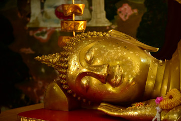 Golden statue of buddha in temple, Thailand	