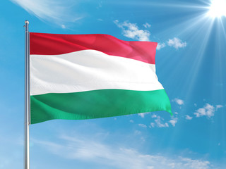 Hungary national flag waving in the wind against deep blue sky. High quality fabric. International relations concept.