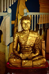 Golden statue of buddha in temple, Thailand	