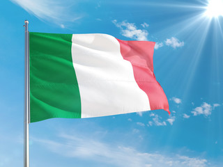 Italy national flag waving in the wind against deep blue sky. High quality fabric. International relations concept.