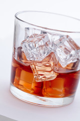 glass of whiskey with ice cubes