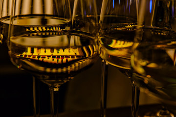 beautiful refraction of light and the reflections in the wine glasses with gold color