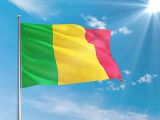 Mali national flag waving in the wind against deep blue sky. High quality fabric. International relations concept.