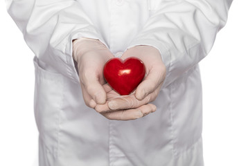 Male doctor in gloves holding heart over white background