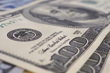 US money banknotes of 100 dollars old and new type close-up. Interest rate of the Federal Reserve System. Emission. National currency. Focus on the Fed stamp. Macro