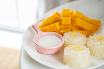 Mango tropical fruit and sticky rice with coconut juice. Thai dessert.