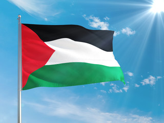 Palestine national flag waving in the wind against deep blue sky. High quality fabric. International relations concept.