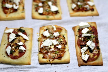 Flatbread with salami, feta cheese and fried vegetables. Selective focus.