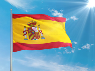 Spain national flag waving in the wind against deep blue sky. High quality fabric. International relations concept.