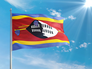 Swaziland national flag waving in the wind against deep blue sky. High quality fabric. International relations concept.