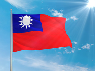 Taiwan national flag waving in the wind against deep blue sky. High quality fabric. International relations concept.