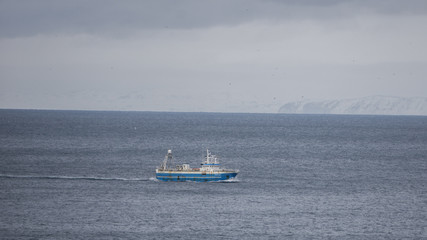 Fototapeta na wymiar A lone fishing trawler somewhere south of Iceland in the Atlantic Ocean.