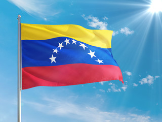 Venezuela national flag waving in the wind against deep blue sky. High quality fabric. International relations concept.