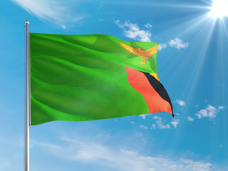 Zambia national flag waving in the wind against deep blue sky. High quality fabric. International relations concept.