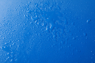 Blue background with water, top view. Wet background