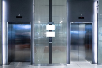 Closed two elevator doors glossy illuminated in hotel © Mumemories