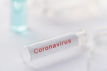 Obraz premium Corona virus Vaccine development Background. Coronavirus testing kit, Blank test tube or glass vile over white laboratory desk for collecting blood sample of chinese virus covid-19 with copyspace. 