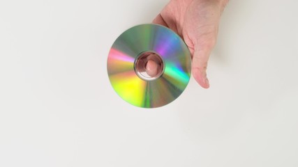 Hand hold disk on white background. Close up.