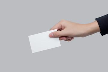 A women hand holding a white card for business on gray background with clipping path