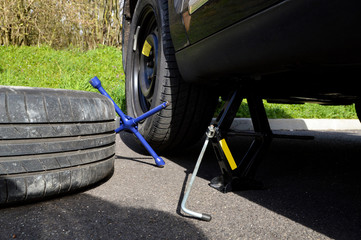 A spare tire and lug wrench and jack, following a tire puncture