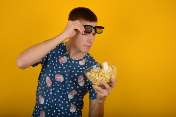 man looking at popcorn in cinema