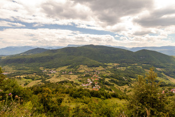 landscape of the village against the background of mountains with clouds