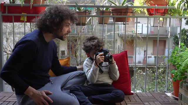 Europe, Italy , Milan - father and son five years at home during quarantine due n-cov19 Coronavirus outbreak - life stile in apartment - learning to take pictures - photography lesson